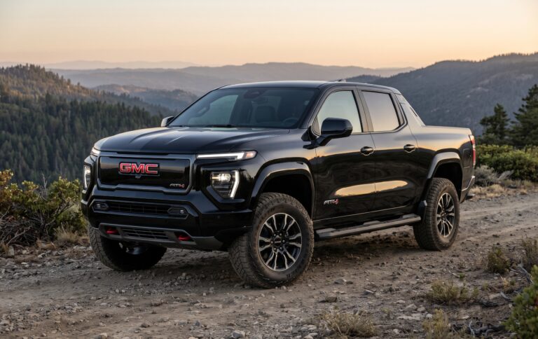 Black GMC Sierra EV AT4 truck parked on a scenic mountain overlook for export / import GMC from USA services.
